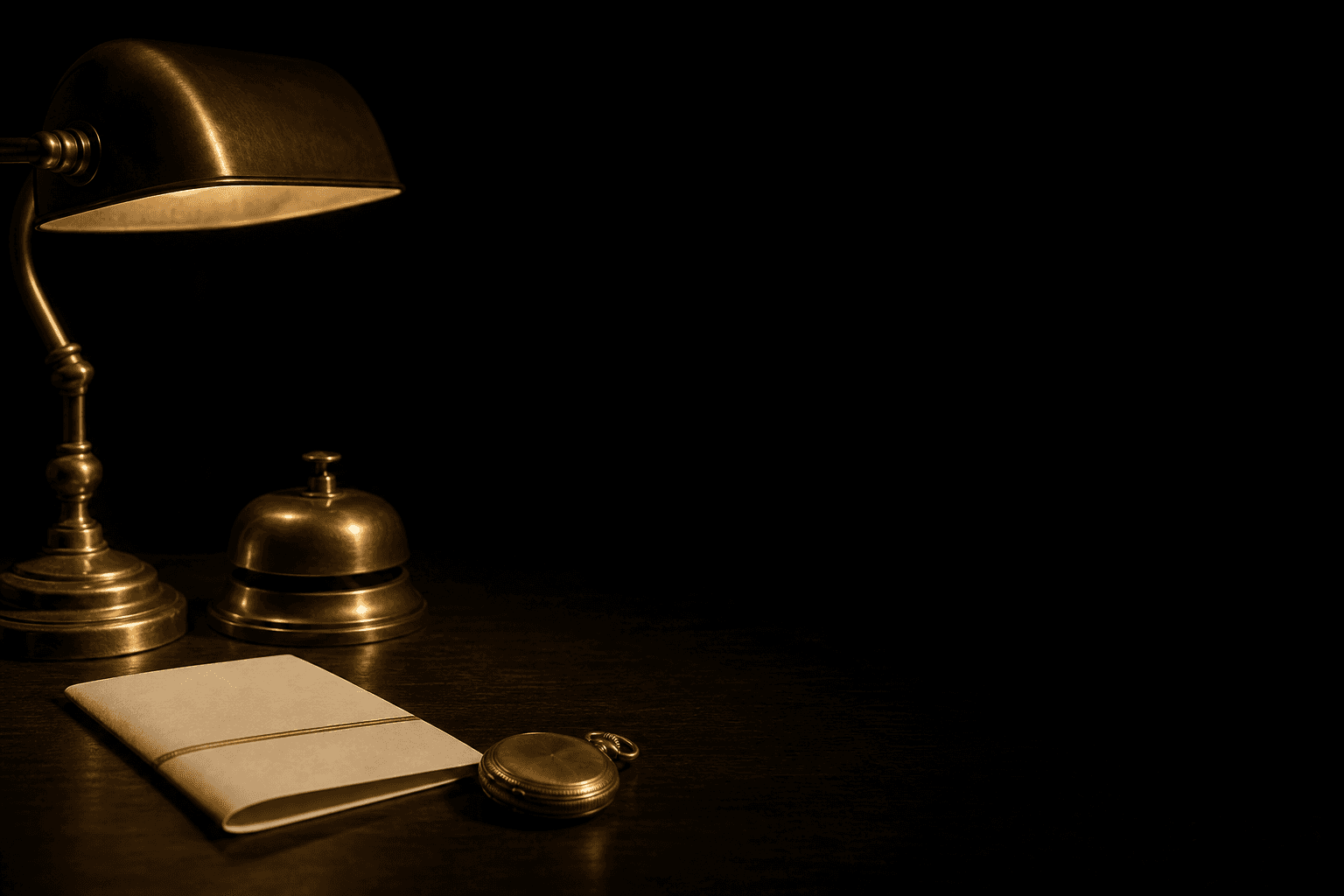 A brass bell, a folded programme and a pocket watch on a dark desk, lit by one warm lamp